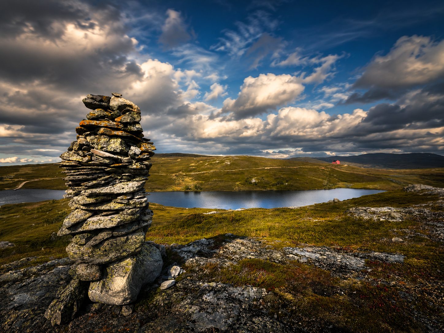 Stone cairn above a tarn in the Howgills
