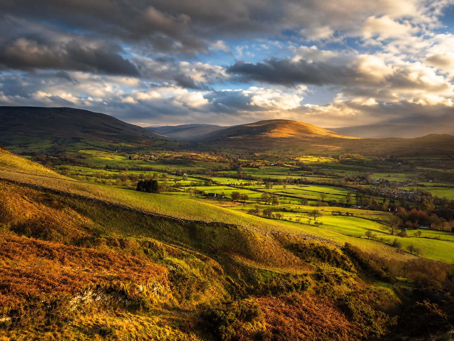 Evening light across the valley below the Howgill Fells